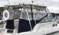 Photo of Boston Whaler Conquest 28, 2000: Hard-Top, Front Visor, Side Curtains, Aft-Drop-Curtain, viewed from Starboard Rear 