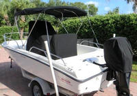 Photo of Boston Whaler Dauntless 200 2008: Bimini Top Console-Cover Reversible Pilot Seat Cover, viewed from Port Rear 