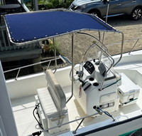 Photo of Boston Whaler Montauk 170, 2008: Montauk T-Topless™ Folding T-Top 2 with, Rear Legs attached to Reversible Pilot Seat Captain-Navy Sunbrella, viewed from Starboard Side 