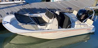 Photo of Boston Whaler Montauk 170, 2020 Montauk T-Topless™ Folding T-Top 2 folded down factory Helm and Reversible Pilot Seat Covers, viewed from Port Front 