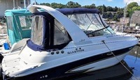 Photo of Glastron GS 259, 2006: Factory Arch Bimini Top, Visor, Side Curtains, Camper Top, Camper Side and Aft Curtains, viewed from Starboard Rear 