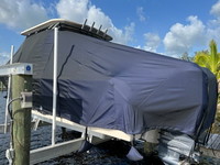 Photo of Grady White Freedom 275, 2013: T-Top Boat-Cover with Sand Bags on Lift, viewed from Port Rear 