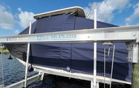 Photo of Grady White Freedom 275, 2013: T-Top Boat-Cover with Sand Bags on Lift, viewed from Port Side 