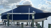 Photo of Grady White Freedom 275, 2013: T-Top Boat-Cover with Sand Bags on Lift, viewed from Starboard Side 