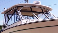 Photo of Grady White Freedom 307, 2013: Factory Hard-Top, Visor, Side Curtains Black Sunbrella, viewed from Starboard Front 