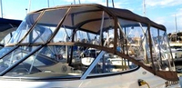 Photo of Larson Cabrio 240, 2004: Bimini Top, Front Connector, Side Curtains, Camper Top, Camper Side and Aft Curtains, viewed from Port Front 