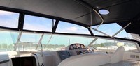 Photo of Rinker 410 Fiesta Vee Express Cruiser Canvas Tops, 2005: Bimini Top with Light, viewed from Ports, Front Connector, Side Curtains, Inside 