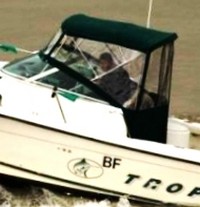 Photo of Trophy 2352 WA, 2000: Fiited with, 2002: Forward Green Bimini Top, Front Connector, Side Curtains, Aft-Drop-Curtain, viewed from Port Side 