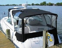 Photo of Factory OEM Rinker 320 Express Cruiser, 2008: Bimini Top, Connector, Side Curtains, Camper Top, Camper Side Aft Curtains open, viewed from port rear   