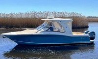 Photo of Scout 275 Dorado, 2018 Hard-Top, Connector, Side Curtains, Aft-Drop-Curtain, Bow Cover, viewed from port side 