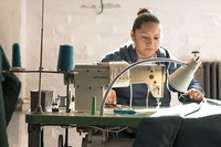 Seamstress sewing new canvas